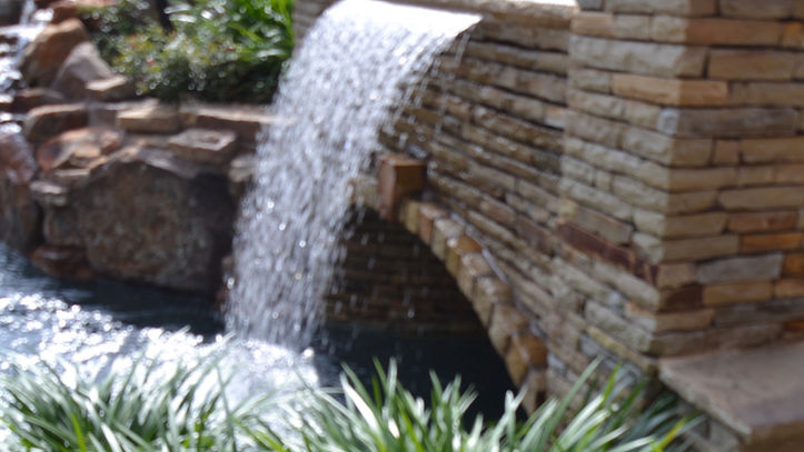 Rain fall on the bridge of the Colleyville Lazy River designed by Mike Farley.