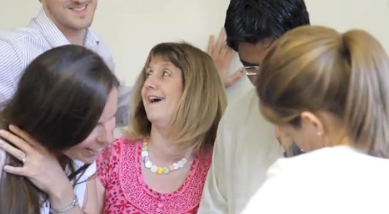 lady in pink dress at a magician team building event done by slightly unusual illusionists