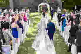 outside wedding with bride and groom walking down to the alter