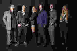 A team of magicians, entertainers and illusionists for slightly unusual pose for the camera at a photoshoot