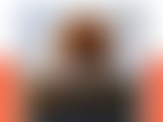 Photo by Cookie the Pom on Unsplash. Brown and white pomeranian dog wearing glasses looking down into a dark grey laptop.