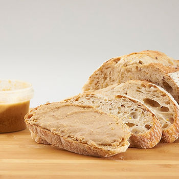 Hazelnut butter on freshly sliced bread.