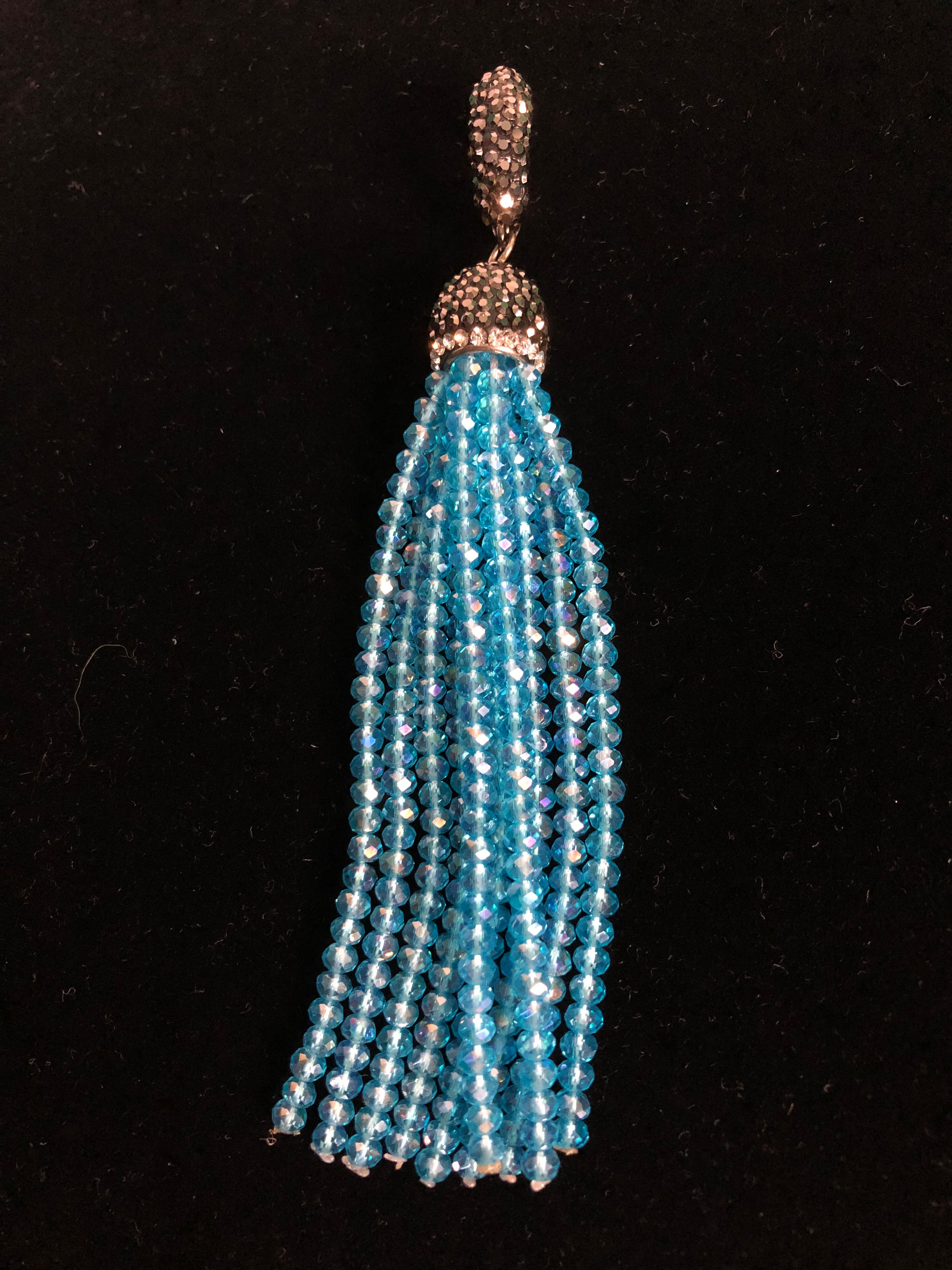 Black encrusted Austrian crystal enhancer with tassel drop