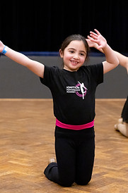 Student dancing in a Kindy level jazz class at Ignition Performance Academy, having fun and smiling.