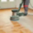 DALL·E 2024-08-03 16.55.32 - A single worker using a drum sander, similar to the one in th