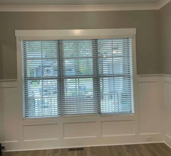 2" faux wood blinds in a white finish over double hung windows in a living room.