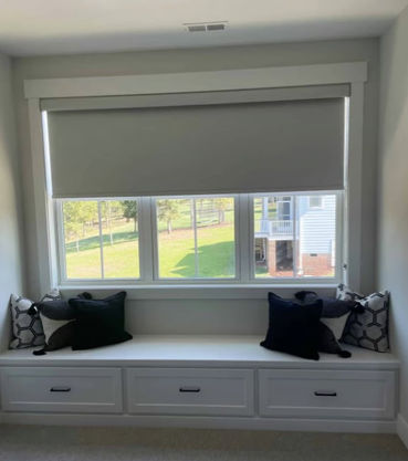 Bonus Room with one inside mounted roller shade in blackout fabric covering three casement windows.