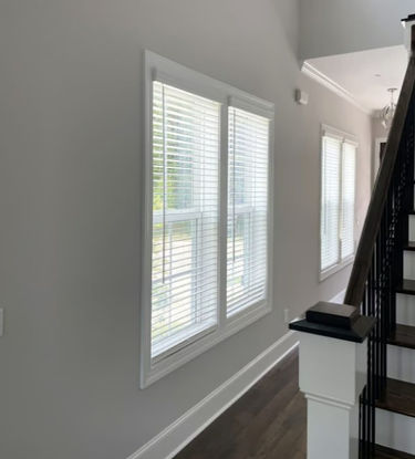 2" faux wood blinds in a white finish over double hung windows in a foyer.