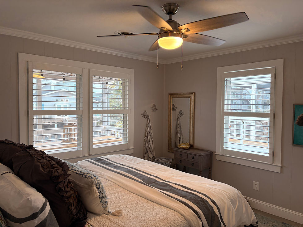 Cozy home in Sunset Beach, NC with large windows featuring plantation shutters.