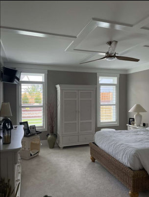 Bedroom with inside mounted 4 1/2" hybrid wood/poly clear-view shutters with divider rails over double-hung windows in a painted finish.
