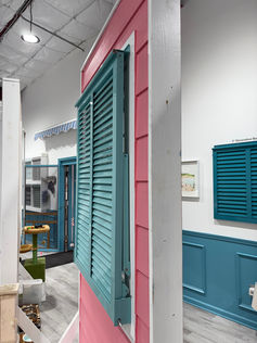 Detailed view of an impact Bahama shutter in pastel teal finish in the fully closed & locked position.