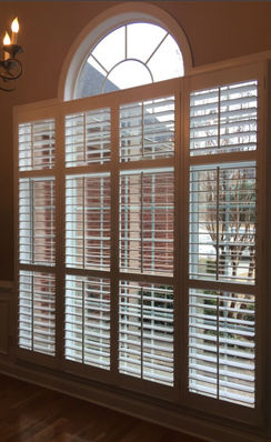 2 1/2" wood shutters with tilt-rods and multiple center rails over double-hung windows in a painted finish.  Outside mount.