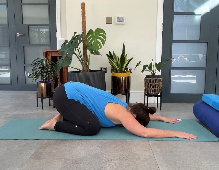 Place your needs wide apart on the mat, toes together to touch, slide your hands away from your body and melt your heart and head to the floor. If your head does not reach the floor, place a block or pillow under your forehead.