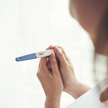 young-woman-hand-holding-pregnancy-test.