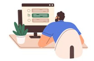 Person sitting a desk looking at a computer