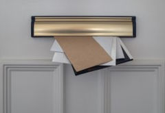 envelopes hanging out of a letterbox