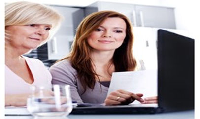 Two women looking at a laptop