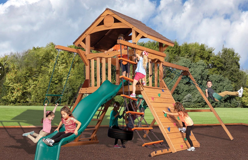 Backyard playground with  slide, swings and climbing wall