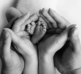 hands-of-parents-the-legs-of-the-newborn