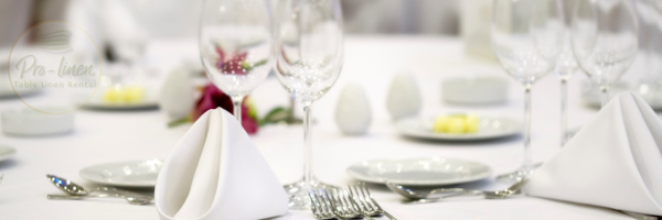 Elegant restaurant table with white linen tablecloth and polished cutlery, showcasing professional restaurant linen hire for a clean and stylish dining setup. Would you like variations for other settings like pubs or cafés?