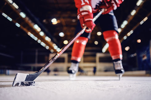Close up of hockey player skating with stick and puck..jpg