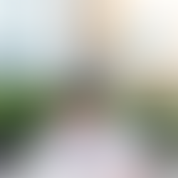 A man in a white shirt sits at a cluttered desk, surrounded by crumpled papers and looking overwhelmed — reflecting the challenges of focus and frustration often experienced with ADHD. Office buildings and trees are visible through a large glass window. The Allied Behavioral Health Solutions logo is shown in the top right corner.