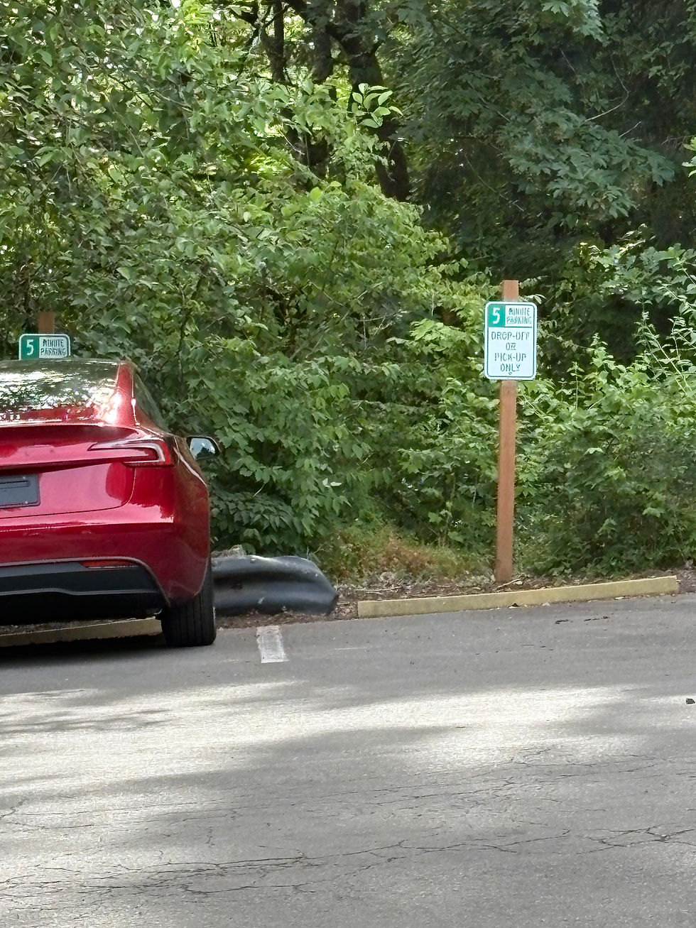 There are 2 parking spaces in the lower parking lot designated for drop off and pick up.