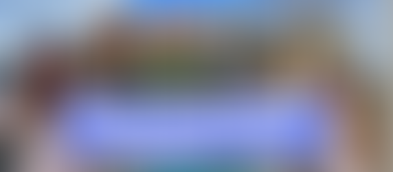 Woman in floral dress smiles in front of coastal view and ancient ruins. Vibrant buildings and blue sky in the background. Text: PRINCESS CRUISE LINES NAPLES “BEST OF THE BAY” SHORE EXCURSION REVIEW.