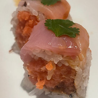 Two pieces of sushi with tuna on top
