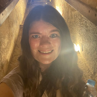 Woman takes a selfie in a dark cavern