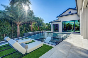Pool space with turf deck, deck level spa, sun shelf and water wall