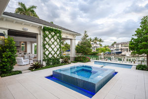 Raised spa with infinity edge and runnel overlooking the canal