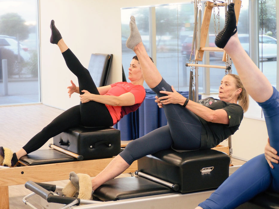 Clients performing a targeted exercise on the original Joseph Pilates apparatus guided by instructor Mary Hurrell in Ferrymead Christchurch