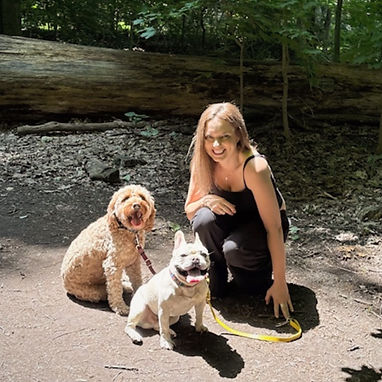 Christina Bowe, founder of Walk Time, smiling with happy dogs during a walk in West Toronto