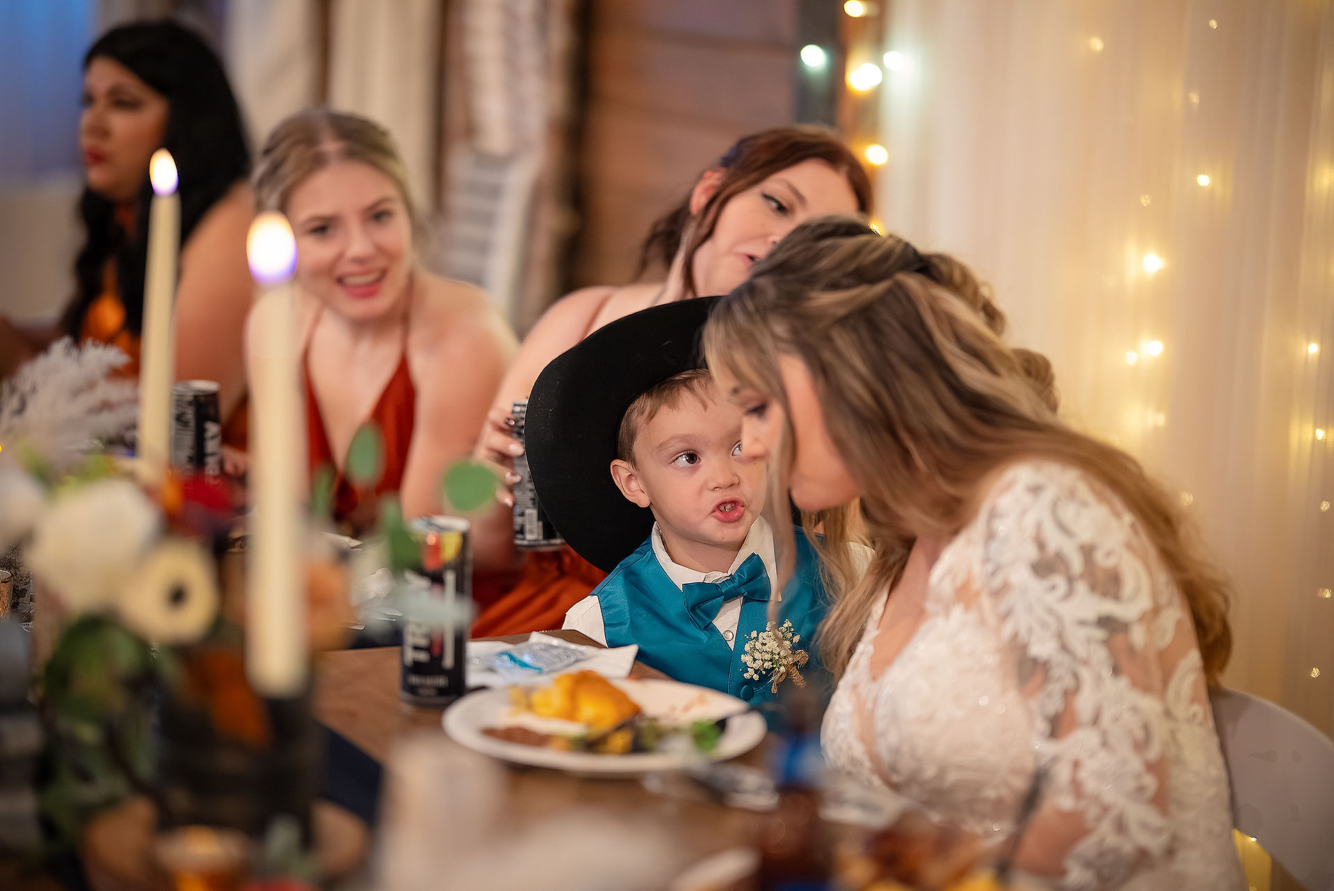 Child talking to bride during wedding reception in toledo wa at country n lace