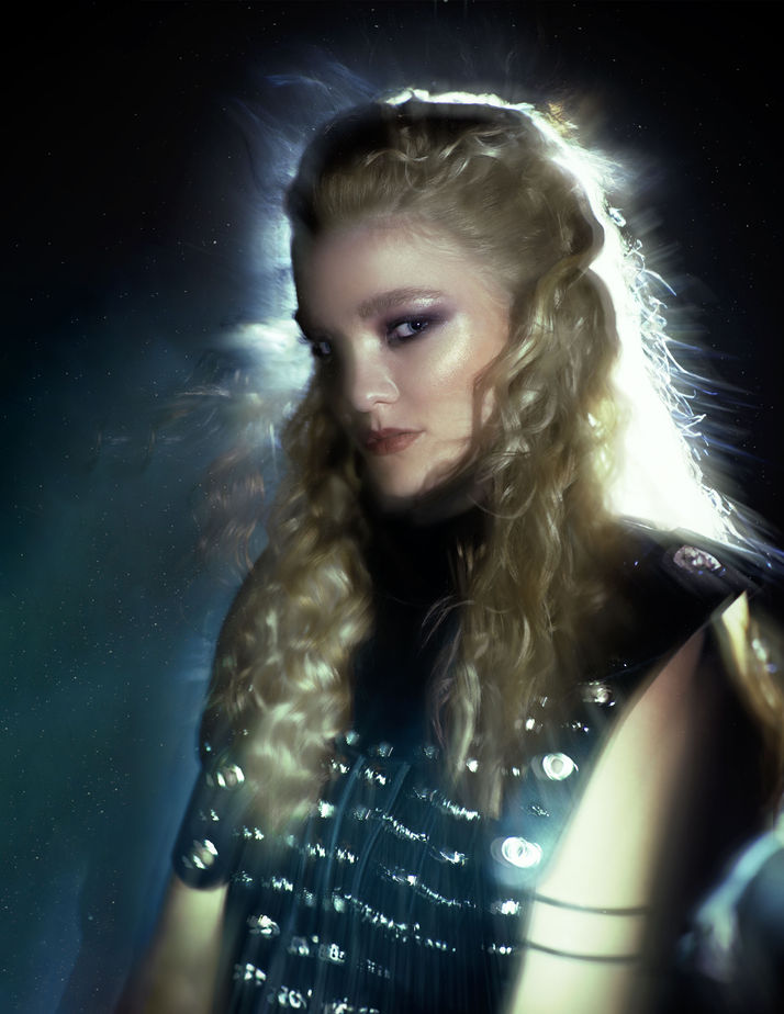 fashion shooting in a black environment with a model wearing glamorous dress