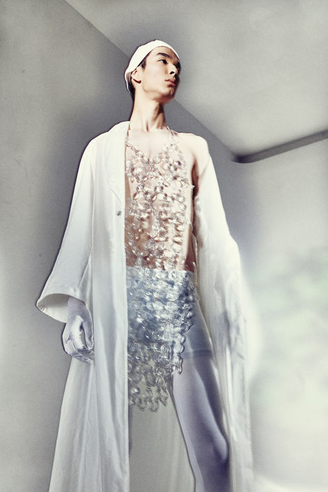 model wearing white long dress in a photographic studio