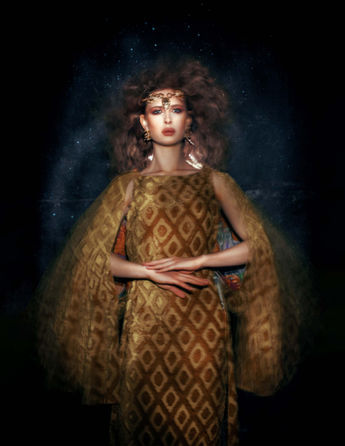 fashion shooting in a black environment with a model wearing glamorous dress