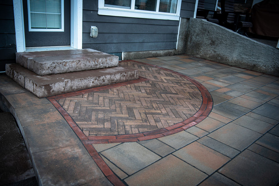 Brick and stone patio with herringbone detail and contrasting border design