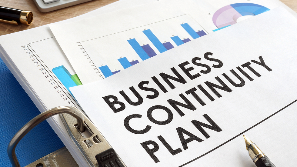 Business Continuity Plan documents organized in a binder, highlighting strategy charts and graphs for maintaining operations during disruptions.