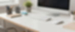 Clean office desk with computer, keyboard, and mouse