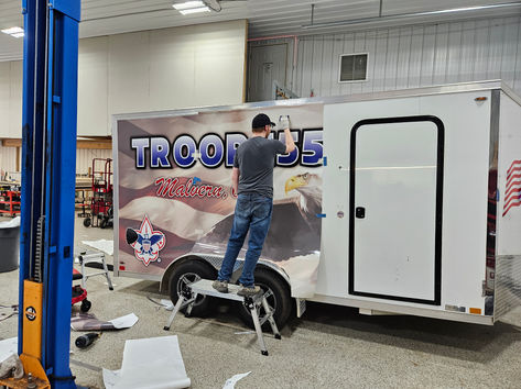 Applying Troop 55 trailer wrap