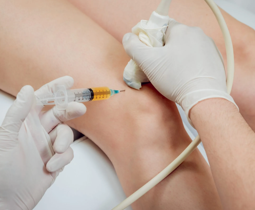 A technician applying an x-ray want to a patients knee