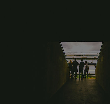 four people standing near gray concrete wall during daytie_edited.jpg