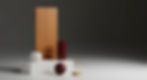 An abstract still life of the Axiom Modern palette: Bone White porcelain, Japanese cypress, an Oxblood accent, and a burnished gold detail.