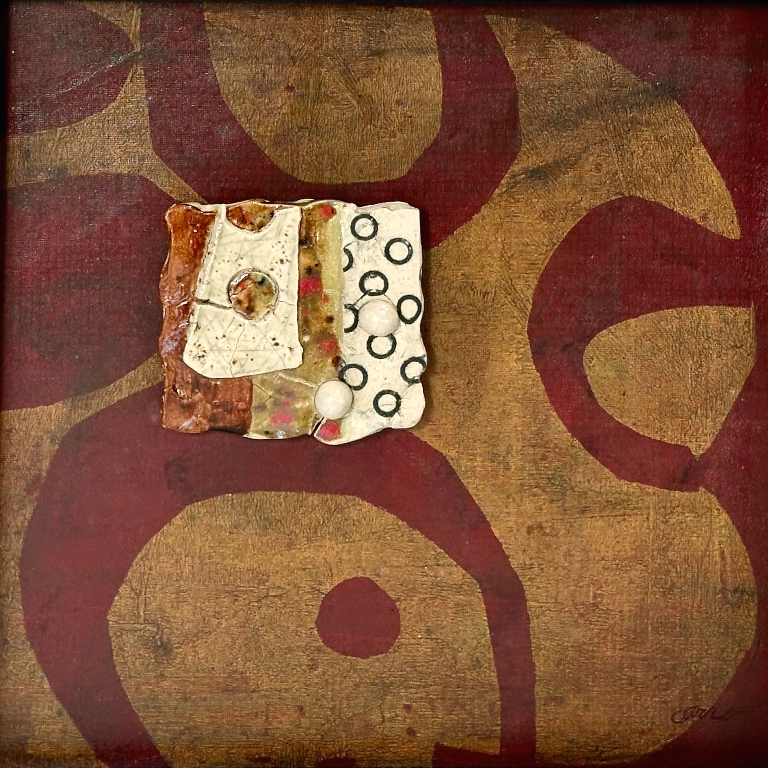 ceramic piece on a gelli print background