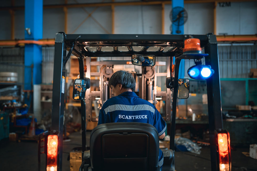 man facing backwards rising the forklift