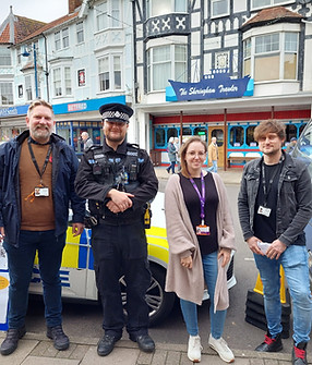 Two staff members out in the community with the police.