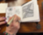 Close-up of a hand drawing a Zentangle pattern, showing the calming, repetitive strokes used for stress relief