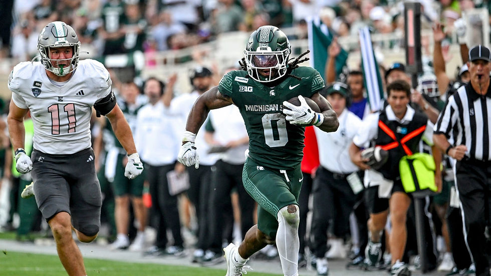Michigan State RB Cam Edwards runs for a gain against Eastern Michigan
